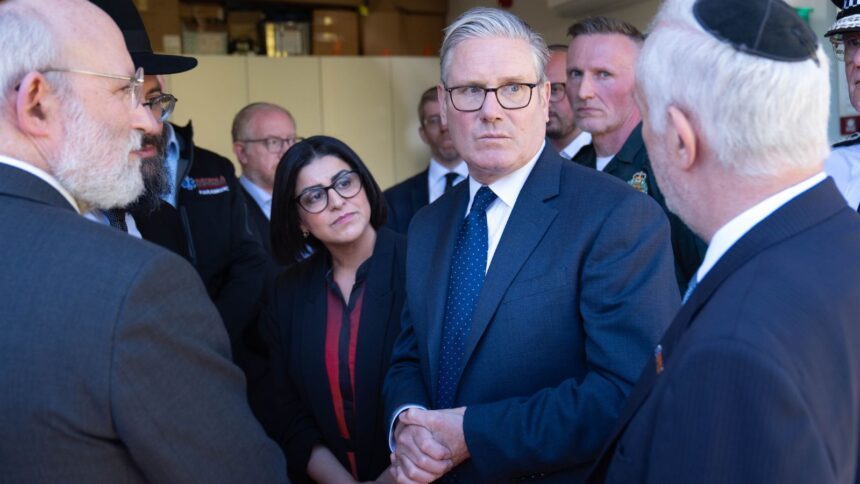 Britain's Prime Minister Keir Starmer, center, and Home Secretary Shabana Mahmood, center left, speak with members of the Jewish community during a visit to Golders Green, north west London, Thursday April 30, 2026, following an attack on Wednesday in which two men were stabbed. (Stefan Rousseau/Pool via AP)