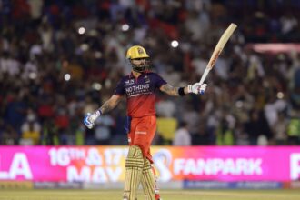 Virat Kohli of Royal Challengers Bengaluru raises his bat after scoring a fifty during Match 57. (Photo by Sumeet Parmar / CREIMAS for IPL)