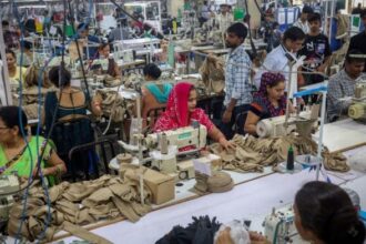 Workers stitch dresses at a garment manufacturing unit in Noida, India, August 27, 2025. REUTERS/Adnan Abidi/File Photo