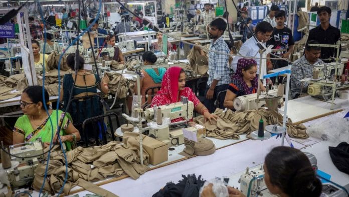 Workers stitch dresses at a garment manufacturing unit in Noida, India, August 27, 2025. REUTERS/Adnan Abidi/File Photo
