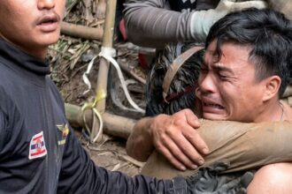 A rescued man is embraced, after seven Lao nationals who had entered a cave to prospect for gold were trapped for more than a week when rising water blocked their exit, in Xaisomboun province, Laos, May 30, 2026, in this screen grab. (REUTERS)
