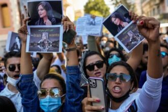 Women hold up drawings of Iranian Mahsa Amini as they shout slogans during a protest against her death, outside Iran's general consulate in Istanbul, Turkey, Wednesday, Sept. 21, 2022. (AP)