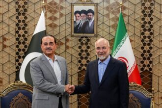 Iran's Parliament Speaker Mohammad Bagher Qalibaf, right, shakes hands with Pakistans Army Chief Field Marshal Gen. Asim Munir during their meeting in Tehran, on Sunday. (AP)