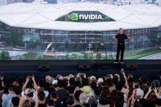 Nvidia CEO Jensen Huang stands in front of the design of its new headquarters displayed on a screen at the Constellation All-Employee Celebration in Taipei, Taiwan, May 27, 2026. (Image: Reuters/Ann Wang)