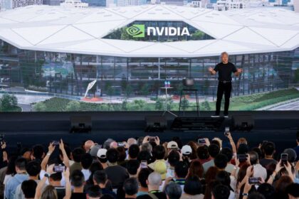 Nvidia CEO Jensen Huang stands in front of the design of its new headquarters displayed on a screen at the Constellation All-Employee Celebration in Taipei, Taiwan, May 27, 2026. (Image: Reuters/Ann Wang)