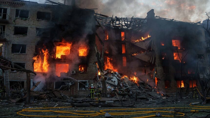 Rescue workers try to put out a fire at a residential building after a Russian strike on Kyiv, Ukraine. (AP Photo)