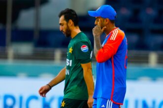 India's captain Suryakumar Yadav, right, and Pakistan's captain Salman Agha walk onto the field before the start of the Asia Cup cricket match between India and Pakistan at Dubai International Cricket Stadium. (AP Photo)