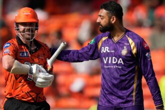 Kolkata Knight Riders' Varun Chakaravarthy pats Sunrisers Hyderabad's Travis Head after taking his wicket during the Indian Premier League cricket match between Sunrisers Hyderabad and Kolkata Knight Riders in Hyderabad , India, Sunday, May 3, 2026. (AP Photo)