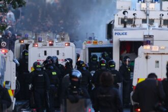 Police use water-cannons to disperse protesters near Newtownabbey, in Belfast, Wednesday, June 10, 2026, following a stabbing incident on Monday night. (AP Photo)