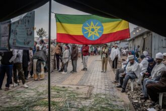 Ethiopian voters gather outside a polling station before voting begins in the general election in Addis Ababa, Ethiopia. (AP Photo)
