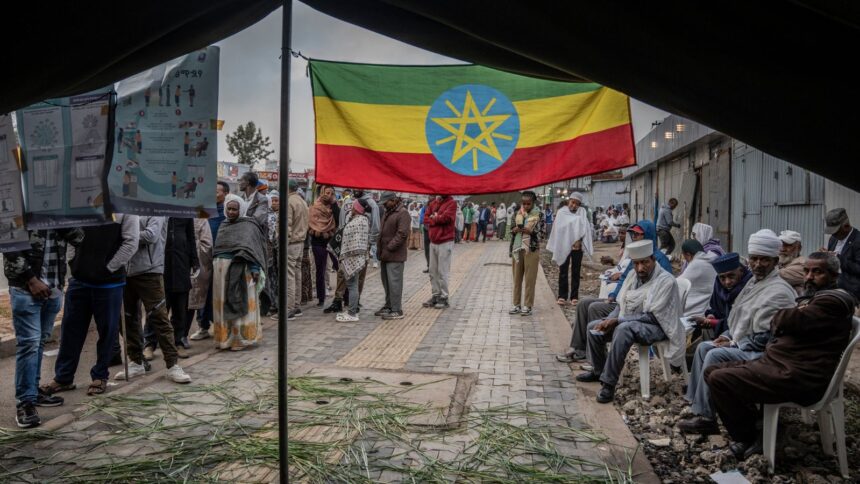Ethiopian voters gather outside a polling station before voting begins in the general election in Addis Ababa, Ethiopia. (AP Photo)