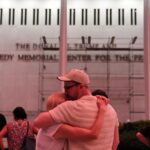 A couple kiss in front of the John F. Kennedy Center for the Performing Arts, Friday, June 12, 2026, in Washington. (AP Photo)