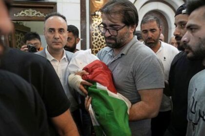 Fahd Abu Haikal, 41 carries the body of his seven month old Palestinian baby boy Sam, who was killed on Friday when, according to the Palestinian health ministry, Israeli soldiers fired at the vehicle carrying him and his parents in Tel Rumeida, during his funeral in the West Bank city of Hebron, Saturday, June 6, 2026. (AP Photo/Mahmoud Illean)