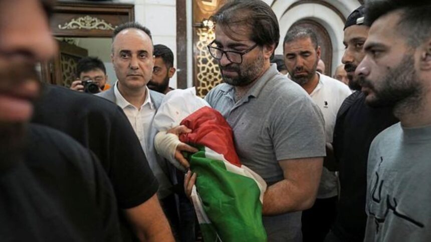 Fahd Abu Haikal, 41 carries the body of his seven month old Palestinian baby boy Sam, who was killed on Friday when, according to the Palestinian health ministry, Israeli soldiers fired at the vehicle carrying him and his parents in Tel Rumeida, during his funeral in the West Bank city of Hebron, Saturday, June 6, 2026. (AP Photo/Mahmoud Illean)