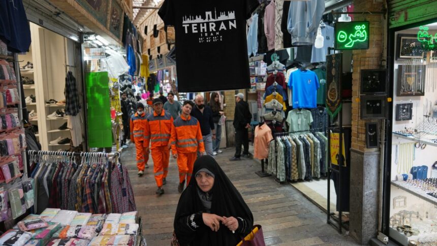 Pedestrians walk through Tajrish Bazaar in Tehran, Iran, Tuesday, April 7, 2026. (AP Photo)