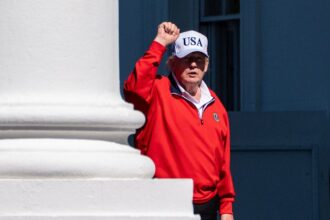 President Donald Trump pumps his fist as he arrives at the White House, Sunday, May 31