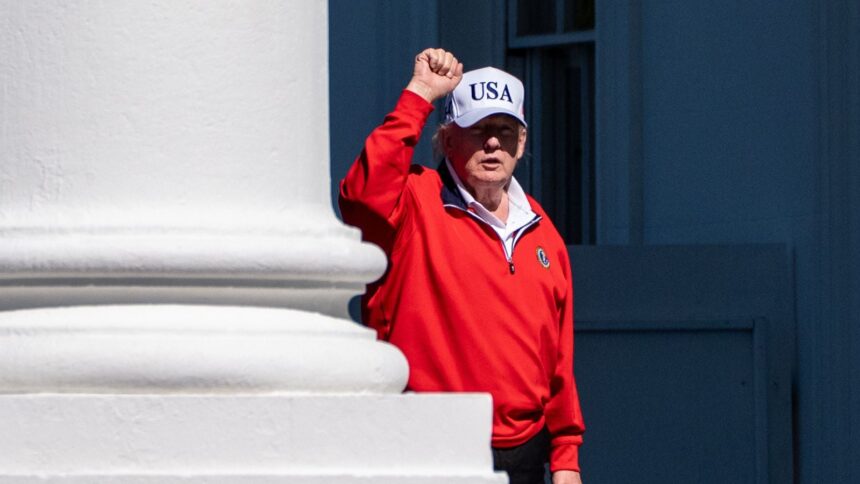 President Donald Trump pumps his fist as he arrives at the White House, Sunday, May 31