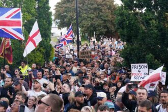 People gather to protest outside Southampton police station, Southampton, England, Tuesday June 2, 2026, after the fatal stabbing of Henry Nowak, a British teenager who was handcuffed despite claiming he was the crime victim.