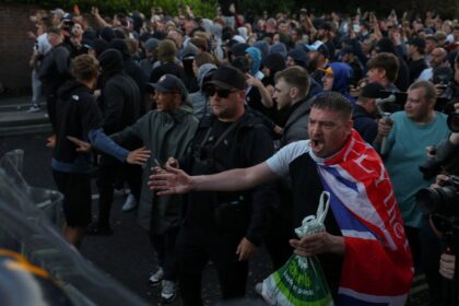 Protesters stand facing police officers during a demonstration following the conviction of Vikrum Digwa for the murder of student Henry Nowak, in Southampton, on June 2, 2026. (REUTERS)