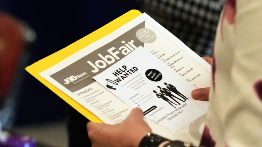 A job seeker waits to talk to a recruiter at a job fair in Sunrise, Florida (AP File Photo)