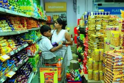A woman with her child is seen buying biscuits at the Big Bazar Store in Ghaziabad. (Pradeep Gaur/Mint)