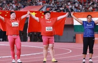 Gold medalist China's Song Jiayuan (C), silver medalist China's Zhang Linru (L) and bronze medalist India's Manpreet Kaur celebrate after the women's shot put final during the 2026 Asian Games in Nagoya on Friday.