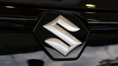 The logo of Maruti Suzuki on a e Vitara SUV car parked inside a showroom in Ahmedabad, India.