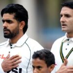 Pakistan's Babar Azam (L) and Mohammad Abbas line up during the national anthems before the match.