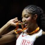 Angel Reese of the US celebrates with her gold medal after winning the FIBA Women's World Cup Final