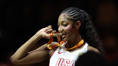 Angel Reese of the US celebrates with her gold medal after winning the FIBA Women's World Cup Final