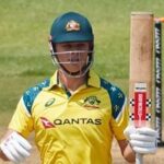Australia's Cooper Connolly raises his bat on scoring a half-century in the second ODI against Zimbabwe.