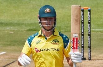 Australia's Cooper Connolly raises his bat on scoring a half-century in the second ODI against Zimbabwe.