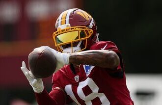 Stefon Diggs #18 of the Washington Commanders participates in a drill during a joint practice.