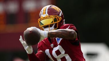 Stefon Diggs #18 of the Washington Commanders participates in a drill during a joint practice.