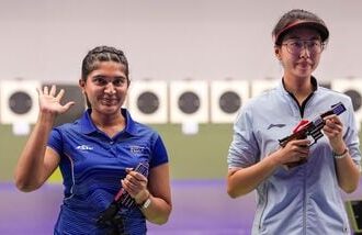 India's Esha Singh (L) greets after securing a silver medal during the women's 25m pistol event at the Asian Games 2026.