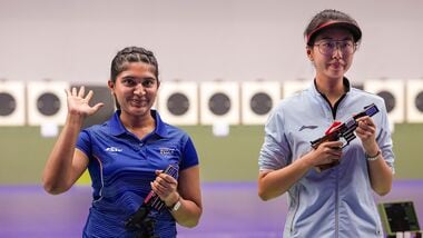 India's Esha Singh (L) greets after securing a silver medal during the women's 25m pistol event at the Asian Games 2026.