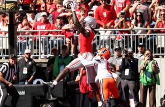 Jeremiah Smith #4 of the Ohio State Buckeyes catches a pass for a touchdown while being defended by Juice Clarke #6 of the Illinois Fighting Illini during the first quarter of the game at Ohio Stadium on September 26, 2026 in Columbus, Ohio.
