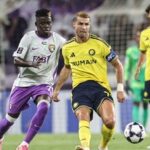 Ain's Guinean midfielder #70 Abdoul Karim Traore (C-L) and Nassr's Portuguese forward #07 Cristiano Ronaldo fight for the ball during the AFC Champions League Elite (ACL) football match between Al-Ain and Al-Nassr at the Azza Bin Zayed stadium.