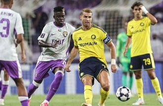Ain's Guinean midfielder #70 Abdoul Karim Traore (C-L) and Nassr's Portuguese forward #07 Cristiano Ronaldo fight for the ball during the AFC Champions League Elite (ACL) football match between Al-Ain and Al-Nassr at the Azza Bin Zayed stadium.