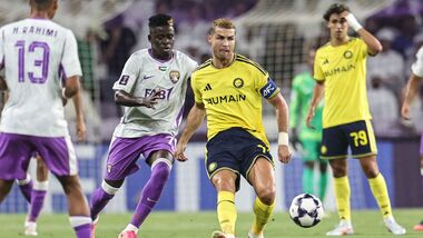 Ain's Guinean midfielder #70 Abdoul Karim Traore (C-L) and Nassr's Portuguese forward #07 Cristiano Ronaldo fight for the ball during the AFC Champions League Elite (ACL) football match between Al-Ain and Al-Nassr at the Azza Bin Zayed stadium.