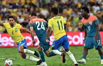 Brazil's Marquinhos (L) and Australia's Paul Okon-Engstler (2nd-L) compete for the ball as Australia's Nestory Irankunda watches during the International friendly football match between Australia and Brazil at Queensland Country Bank Stadium in Townsville on September 25, 2026.