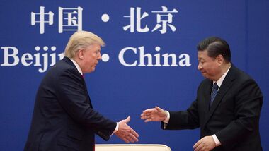 In this file photo, China's President Xi Jinping shakes hands with US President Donald Trump (L) during a business leaders event at the Great Hall of the People in Beijing on November 9, 2017.
