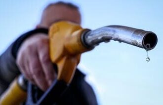 (FILES) A drop of petrol falls from the nozzle of a petrol pump at a petrol station