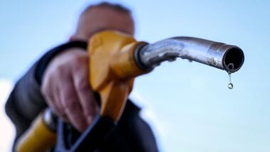 (FILES) A drop of petrol falls from the nozzle of a petrol pump at a petrol station