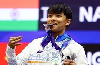 Roshibina Devi poses with her silver medal that she won at Asian Games 2026 in Nagoya.
