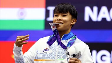 Roshibina Devi poses with her silver medal that she won at Asian Games 2026 in Nagoya.