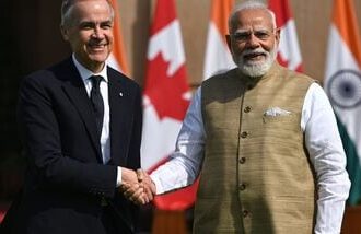 Mark Carney, Canada's prime minister, left, shakes hands with Narendra Modi, India's prime minister, prior to a meeting at Hyderabad House in New Delhi, India, on Monday, March 2, 2026.