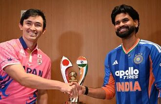 India's captain Shreyas Iyer (R) shakes hands with Japanese captain Kendel Kadowaki-Fleming during a press conference ahead of the one-off T20I.