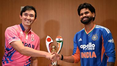 India's captain Shreyas Iyer (R) shakes hands with Japanese captain Kendel Kadowaki-Fleming during a press conference ahead of the one-off T20I.