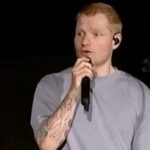 Singer Ed Sheeran speaks on stage as he addresses a controversy over Macklemore being pulled from the tour after saying 'Free Palestine' at a show early this month, in Philadelphia
